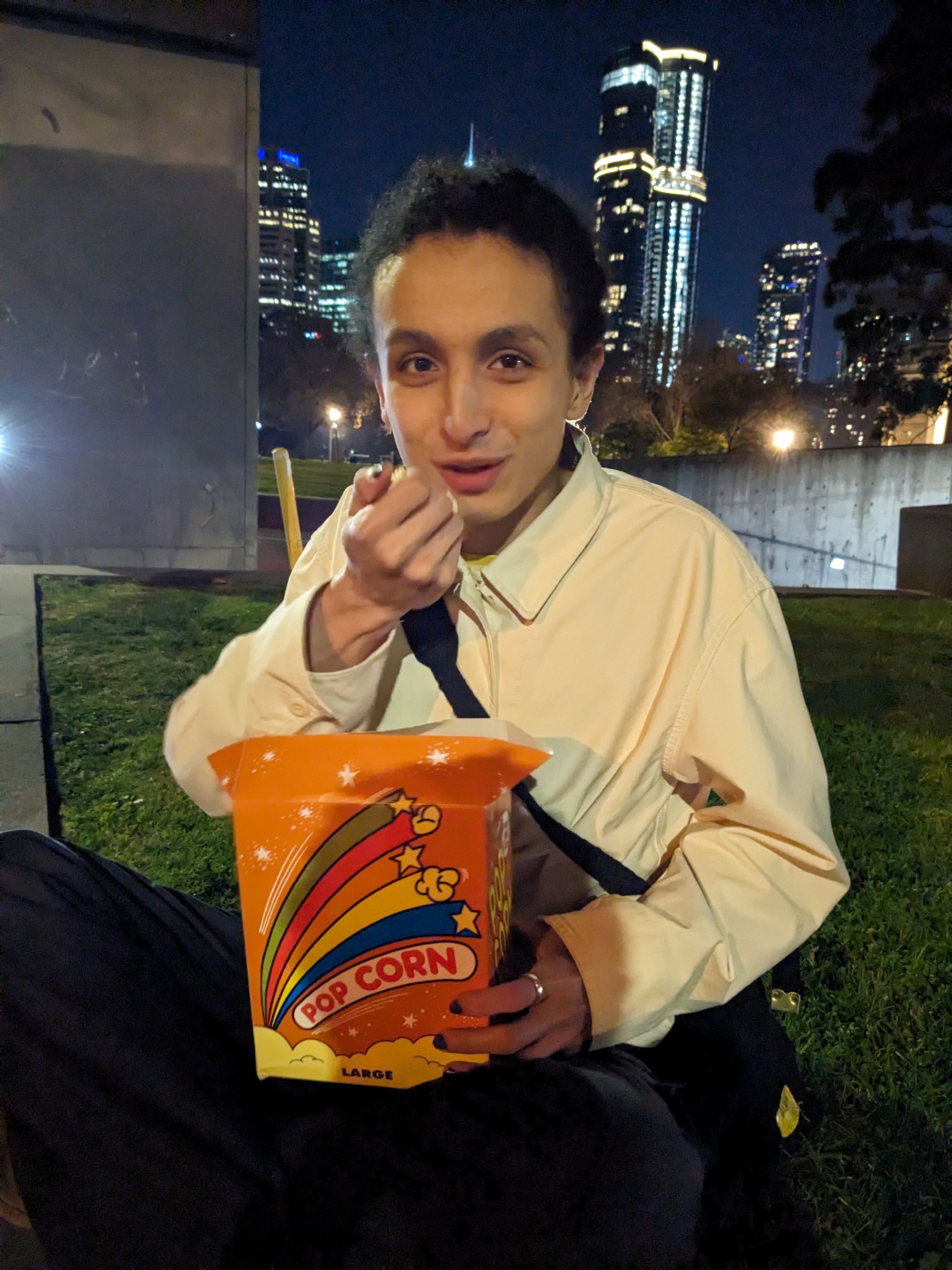 Adam Dinh-Vu with a bucket of popcorn outside the Melbourne Museum